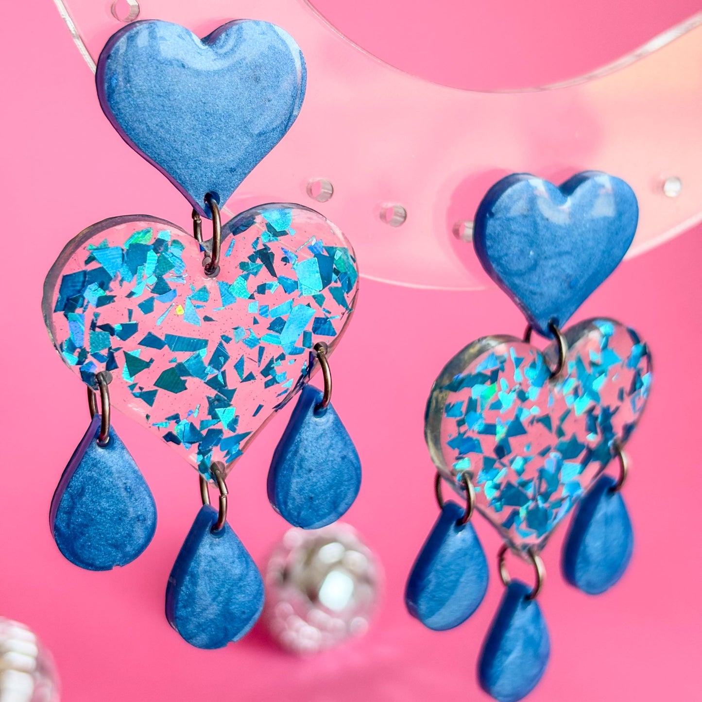 Preciosos pendientes de corazones azules con brillo y lágrimas
